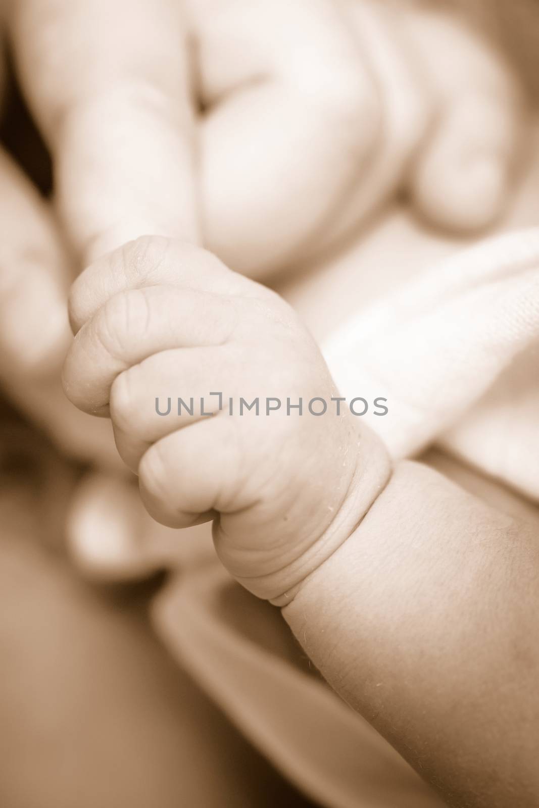 Sepia new-born baby keeps for a  mother's finger. by ngungfoto