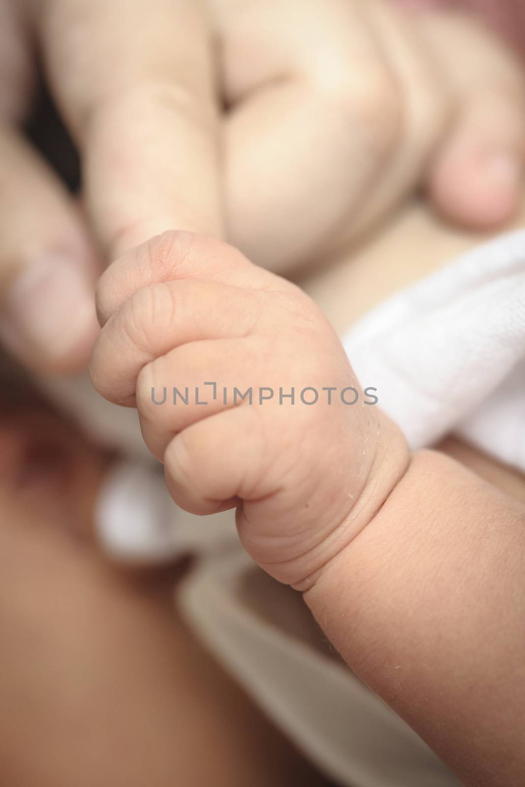 New-born baby keeps for a  mother's finger. by ngungfoto