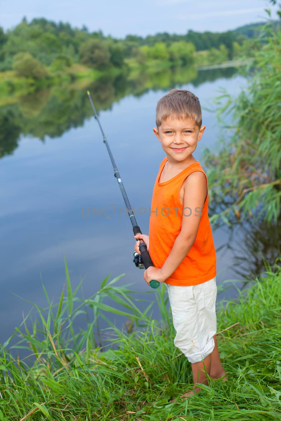 Summer vacation - Photo of little boy fishing on the river.