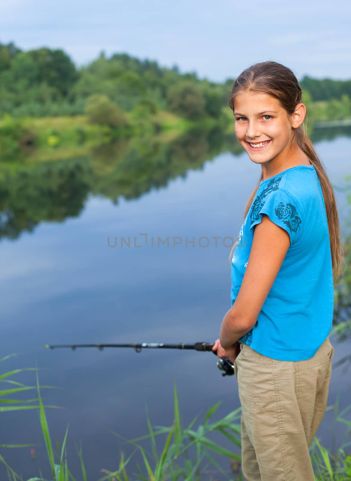 Summer vacation - Photo of cute girl fishing on the river.