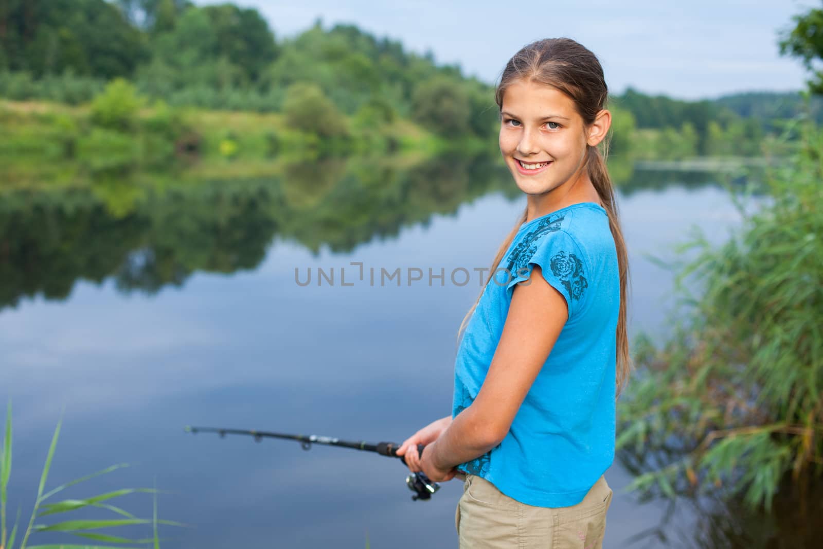 Summer vacation - Photo of cute girl fishing on the river.