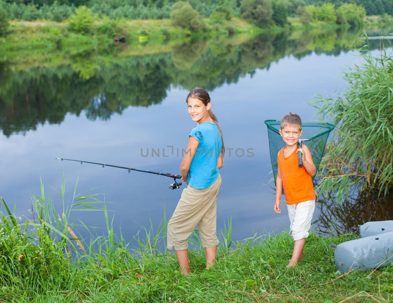 Summer vacation - Sister and brother fishing at the river