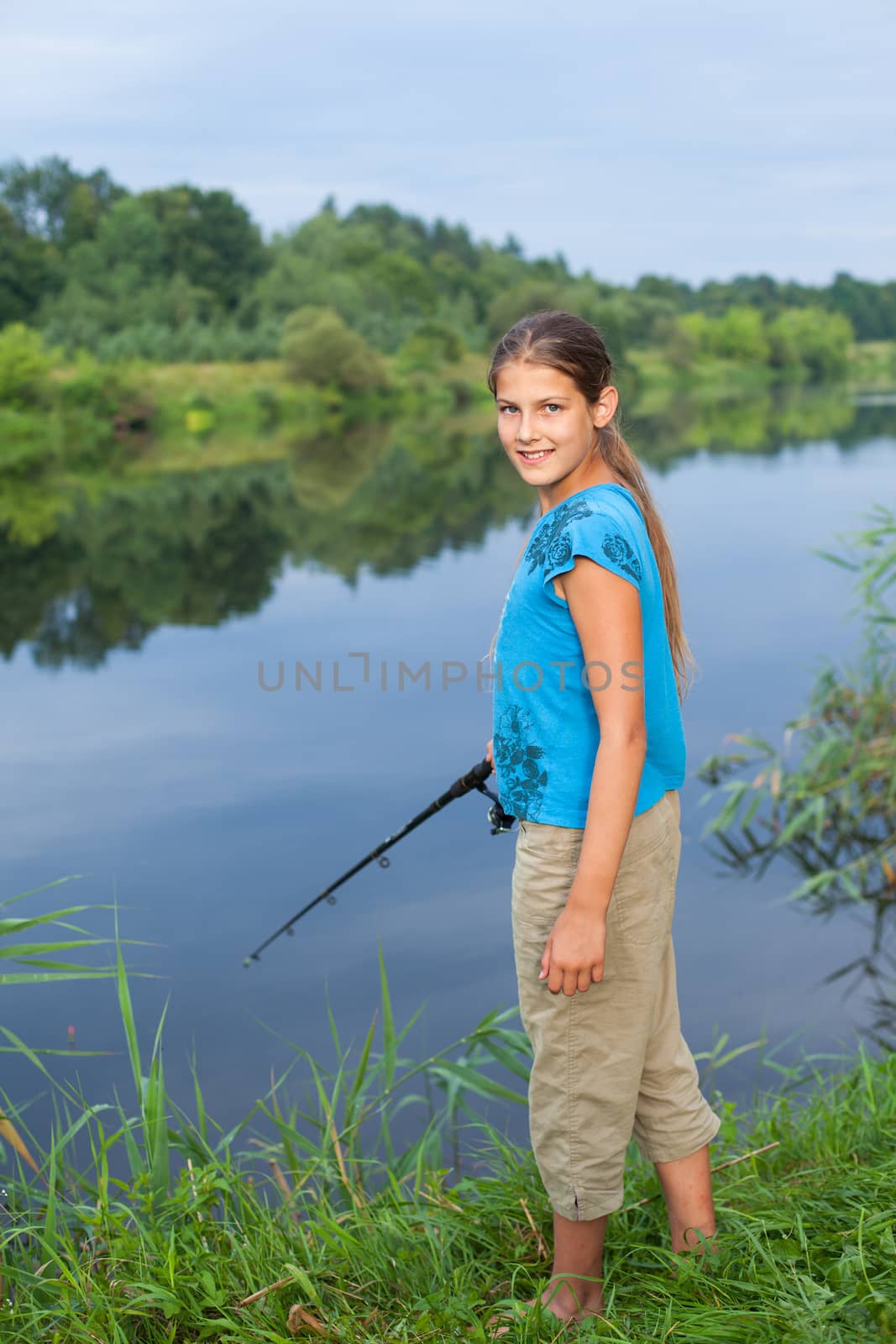 Summer vacation - Photo of cute girl fishing on the river.