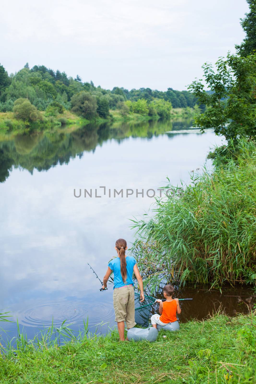 Summer vacation - Sister and brother fishing at the river