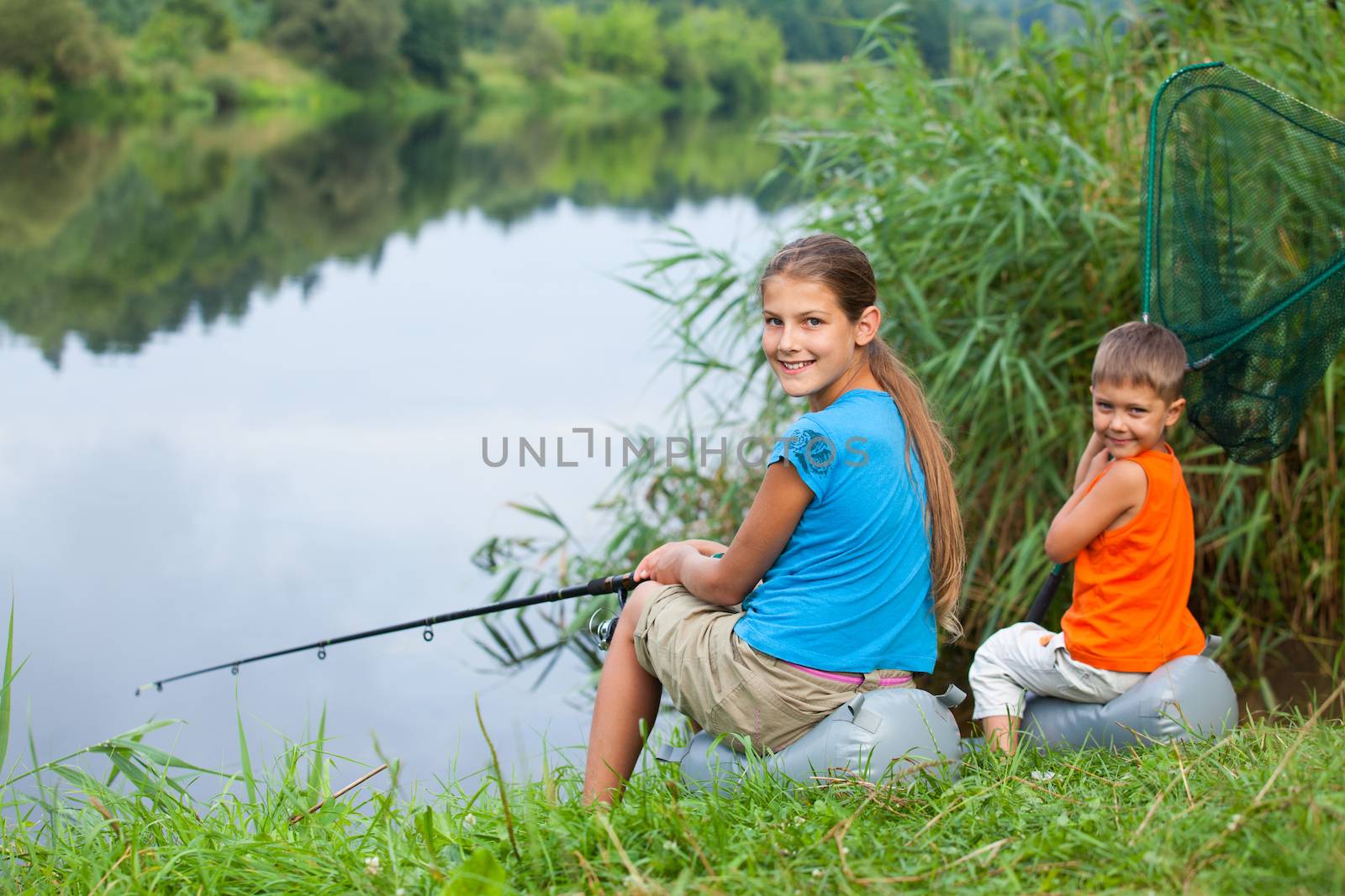 Summer vacation - Sister and brother fishing at the river