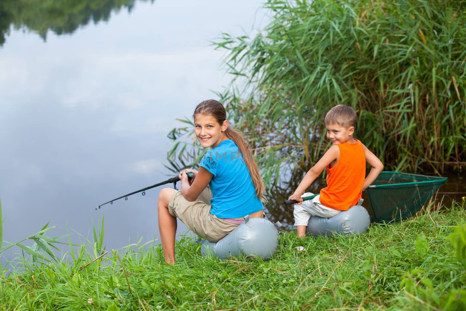 Summer vacation - Sister and brother fishing at the river