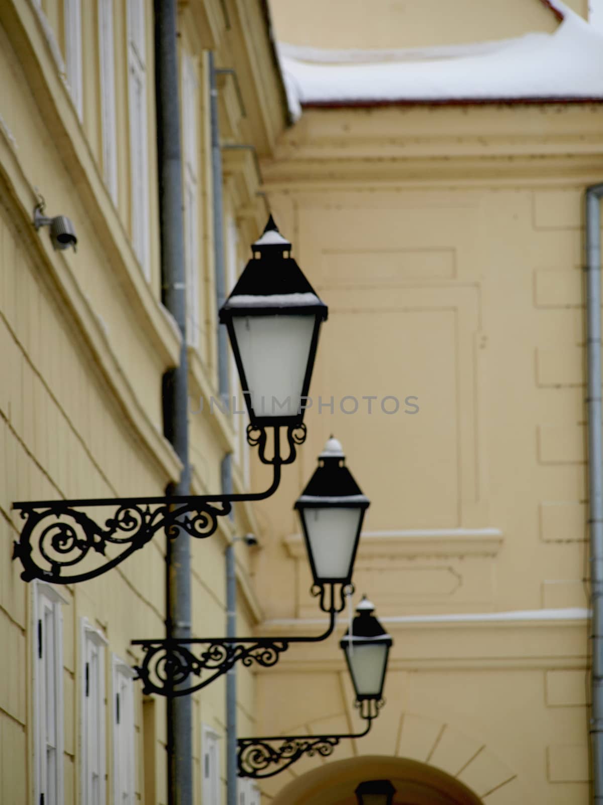 yellow building with windows and street lamp by pm29