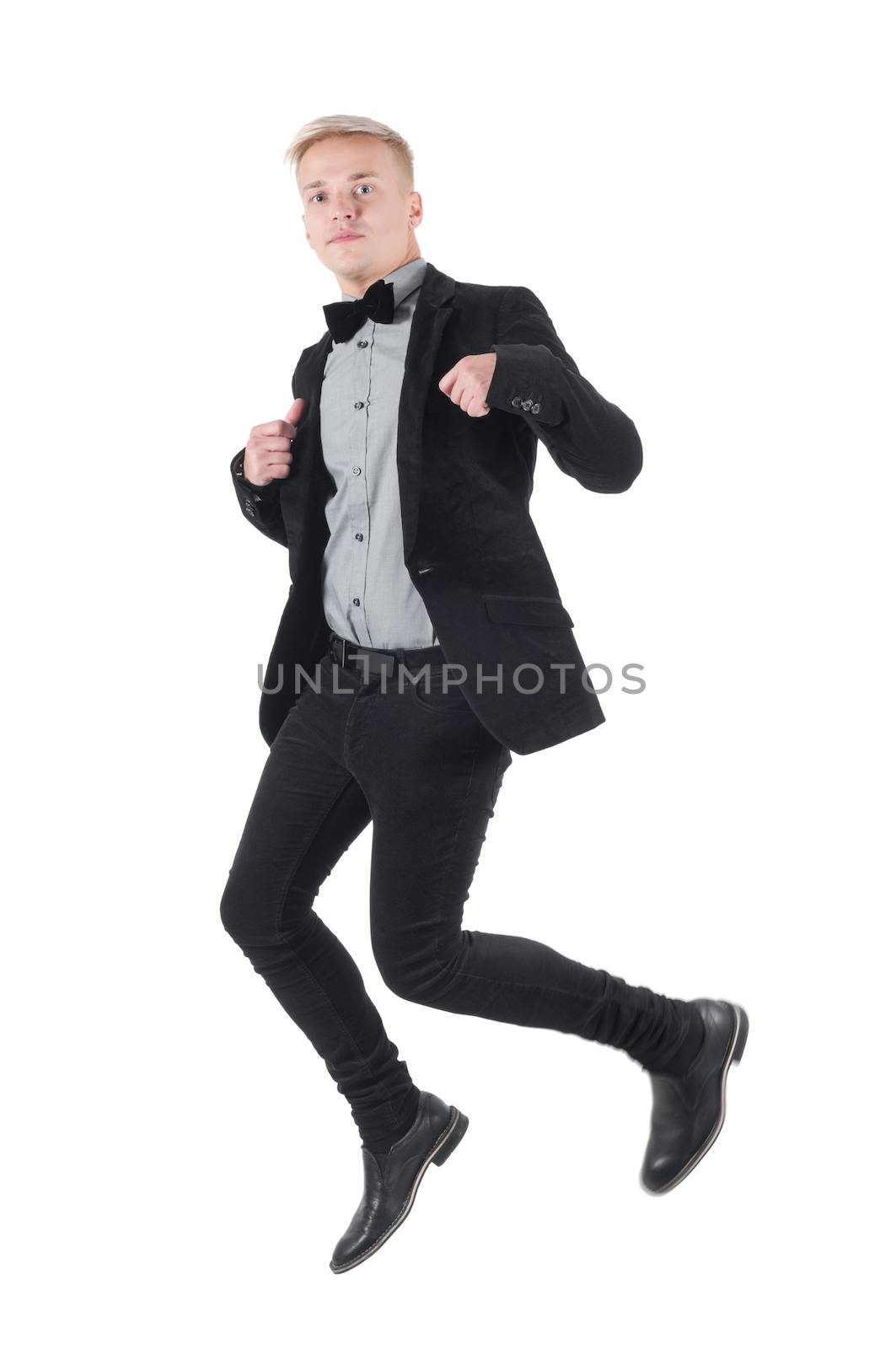 Handsome man in jacket and bow-tie jumping by anytka