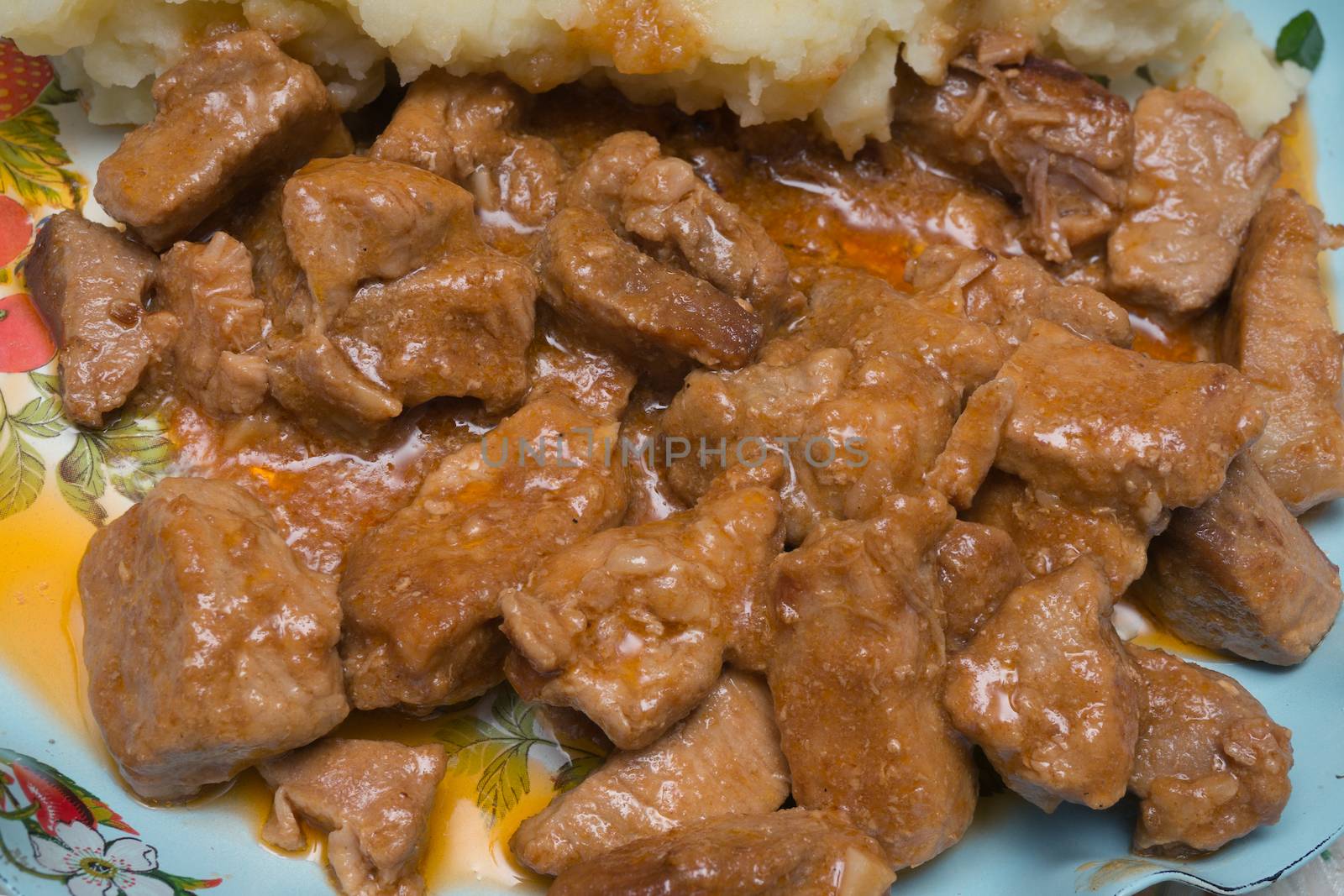 Stewed meat with mashed potatoes on a dish