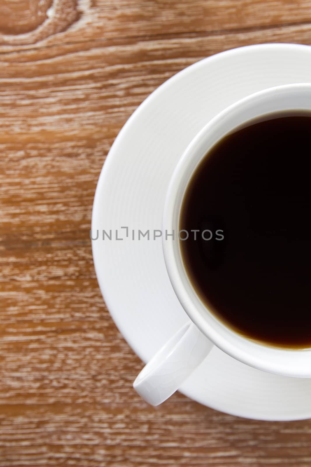 White cup of coffee on wooden table