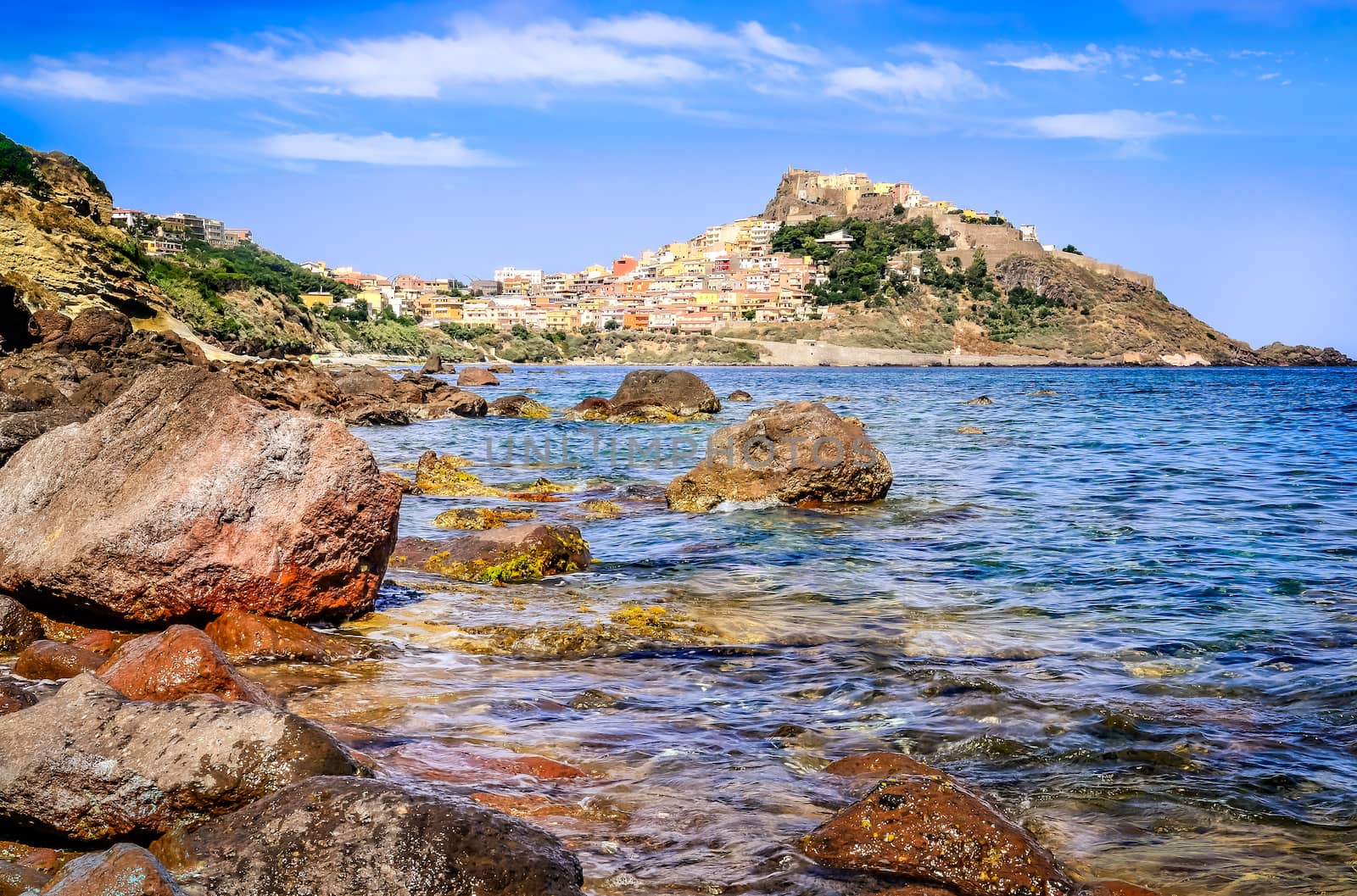 Rocky ocean coastline with colorful town Castelsardo, Sardinia, Italy