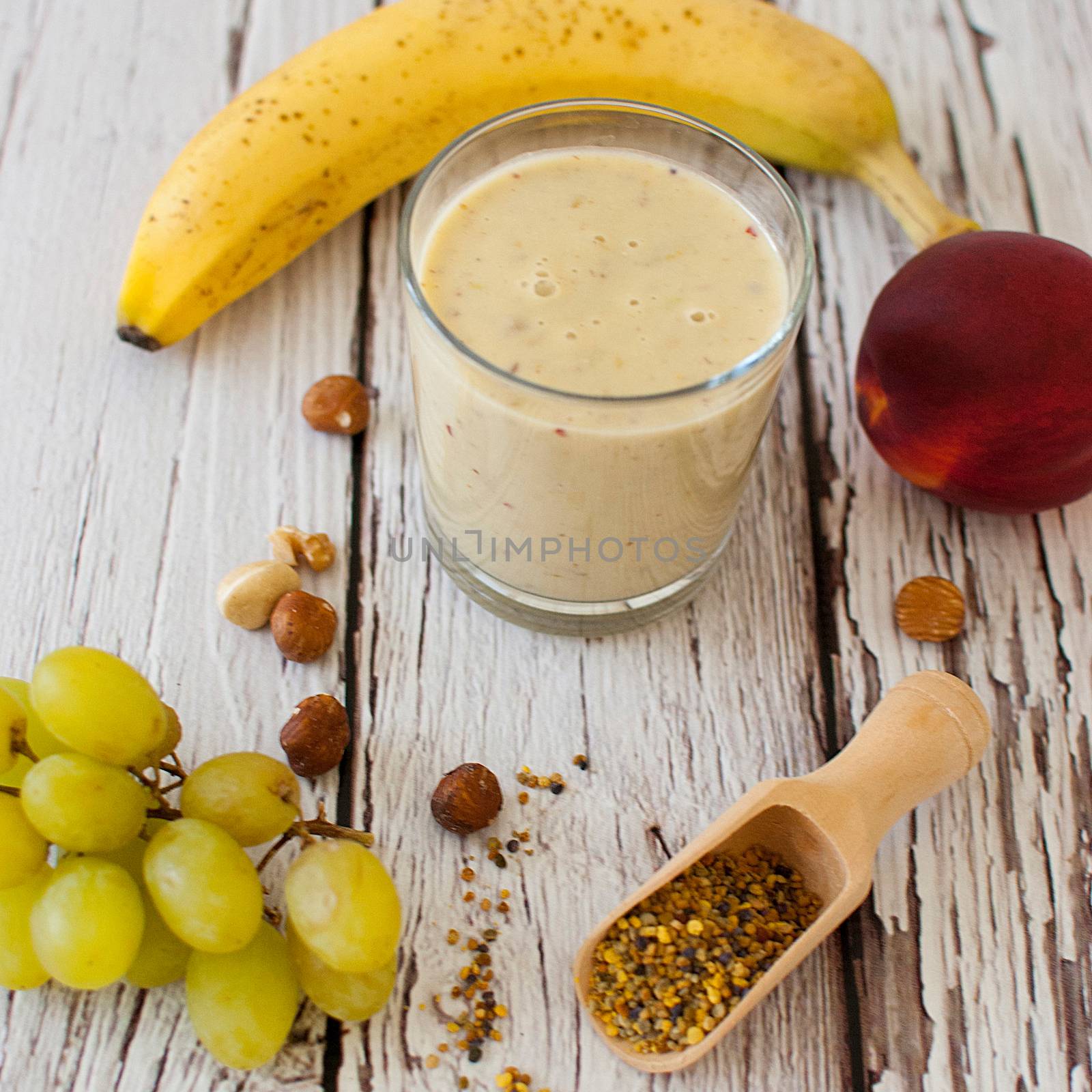 healthy organic fruit and nuts smoothie on wooden board