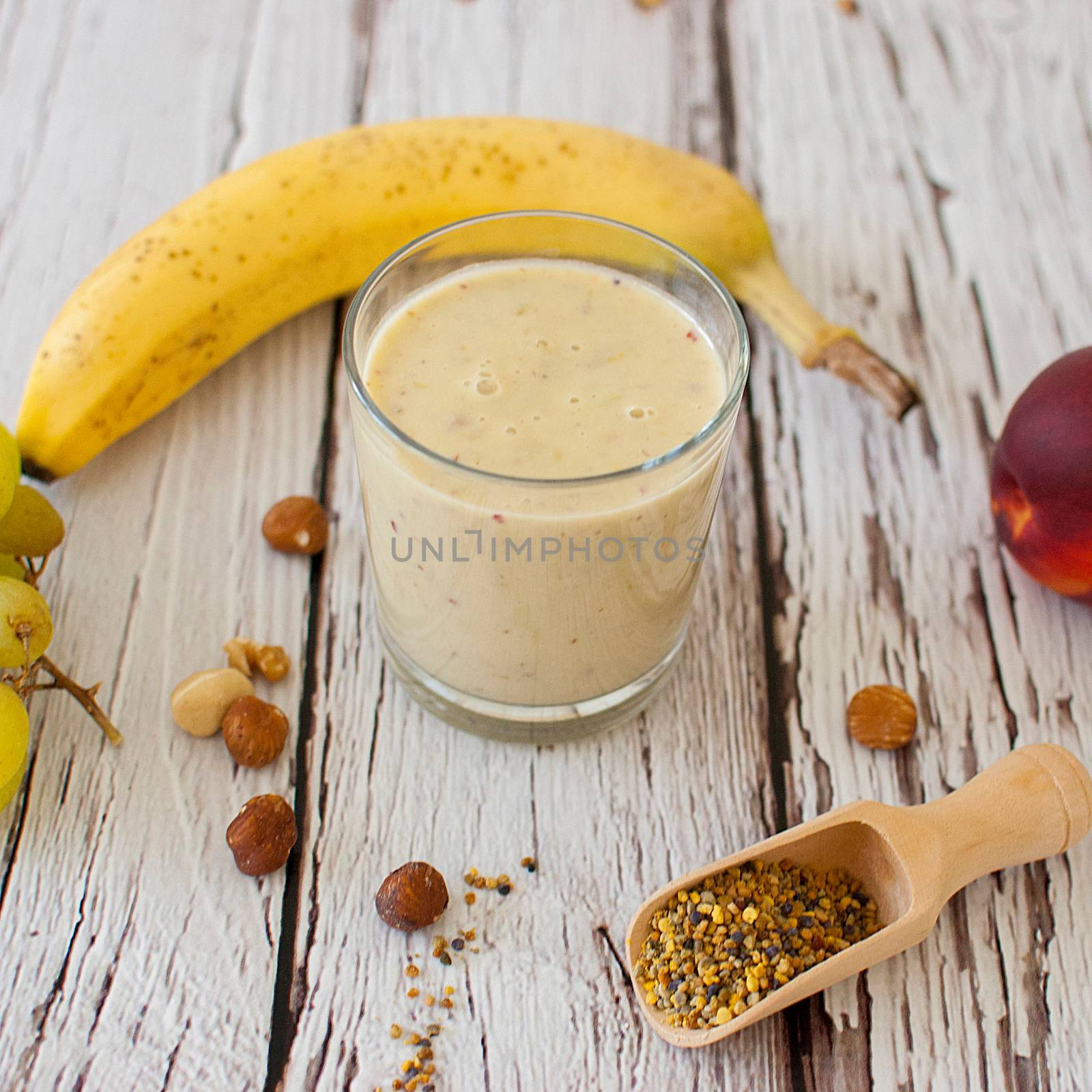 healthy organic fruit and nuts smoothie on wooden board