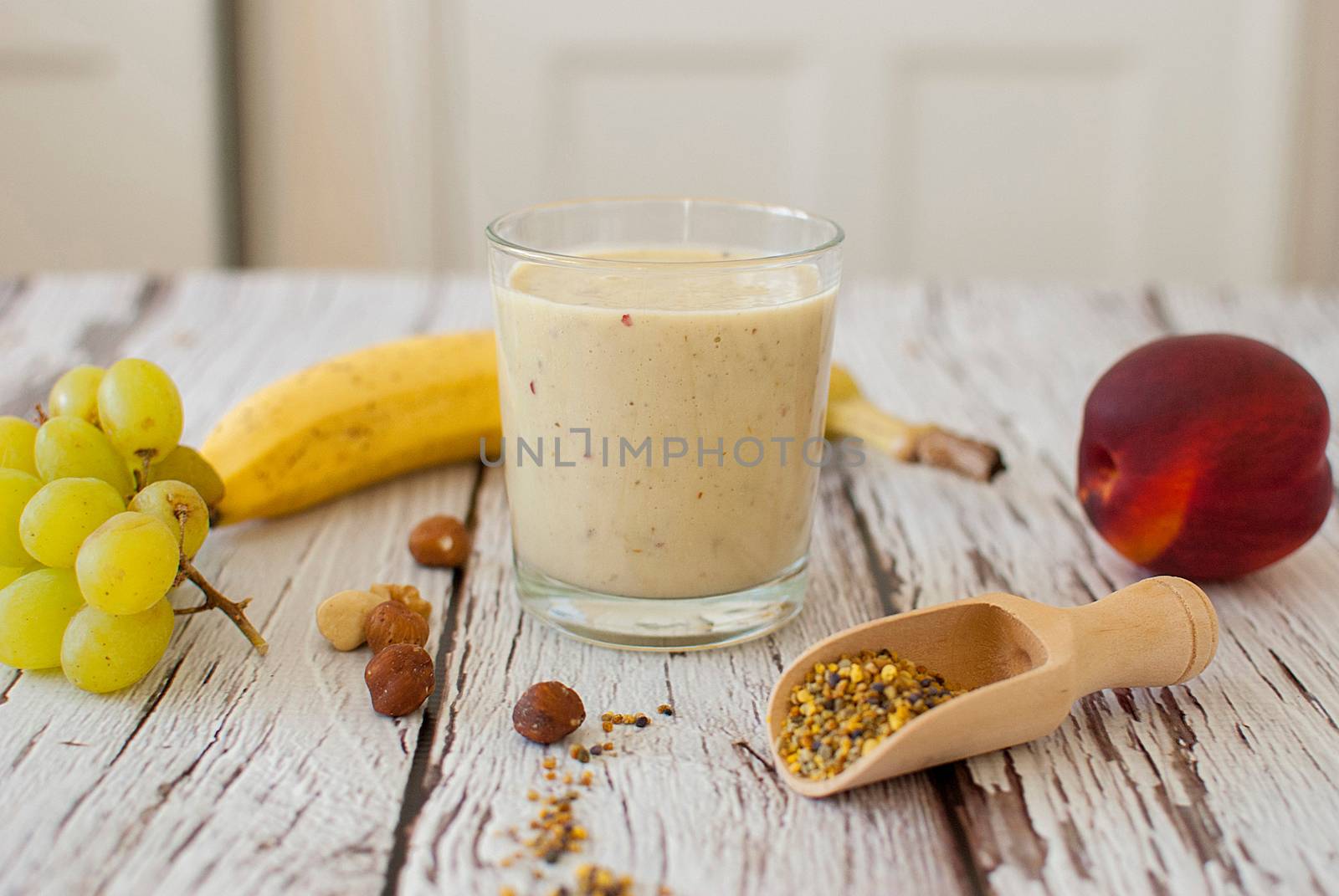 healthy organic fruit and nuts smoothie on wooden board