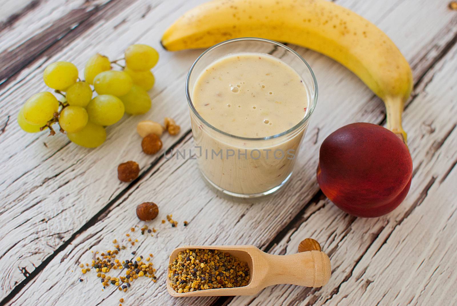 healthy organic fruit and nuts smoothie on wooden board