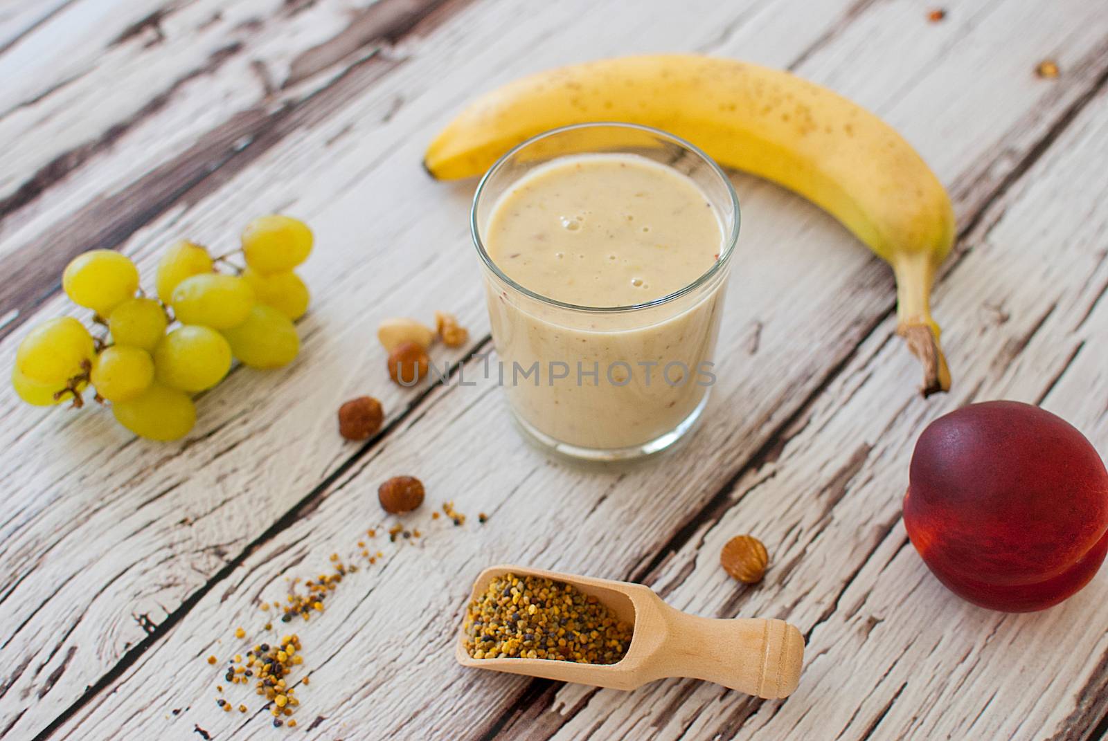 healthy organic fruit and nuts smoothie on wooden board