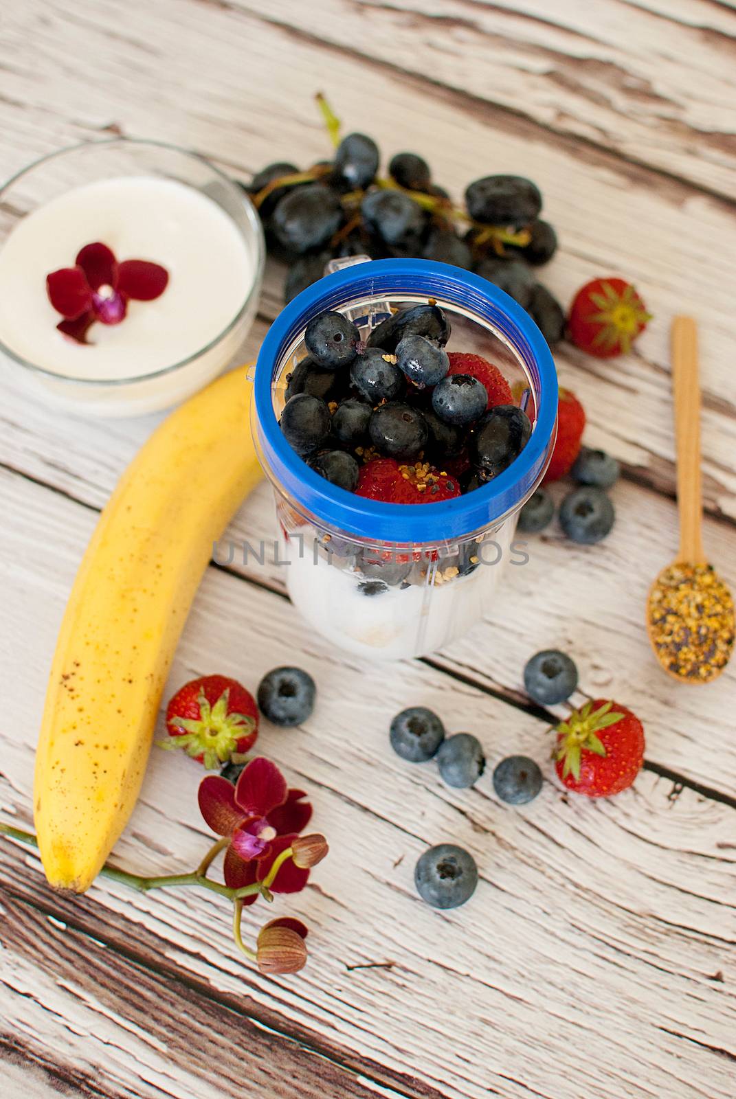 healthy organic fruit and nuts smoothie on wooden board