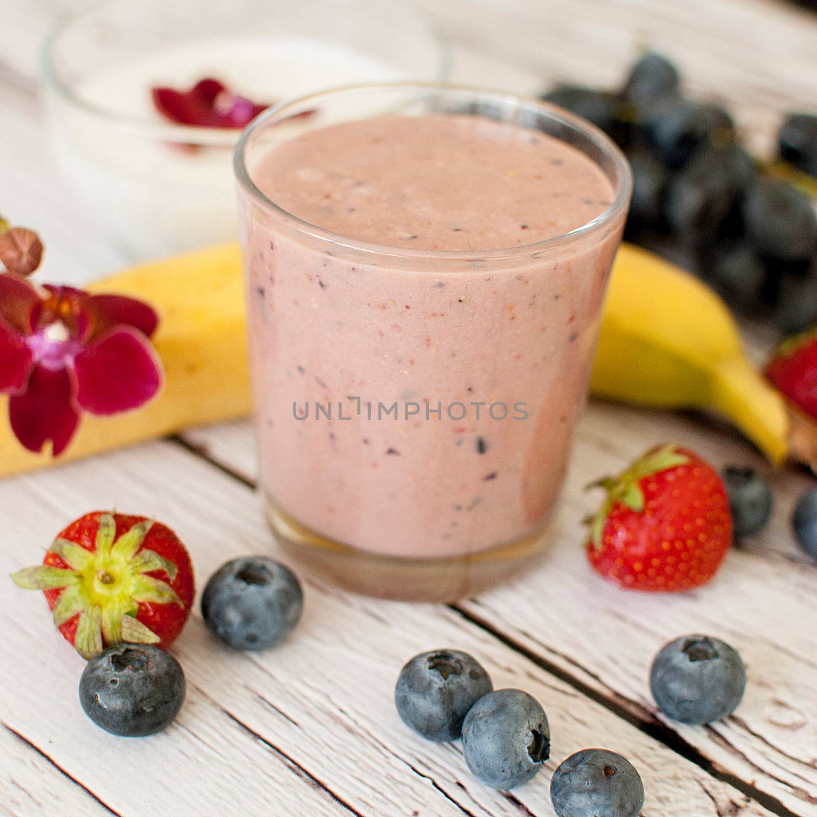 healthy organic fruit and nuts smoothie on wooden board