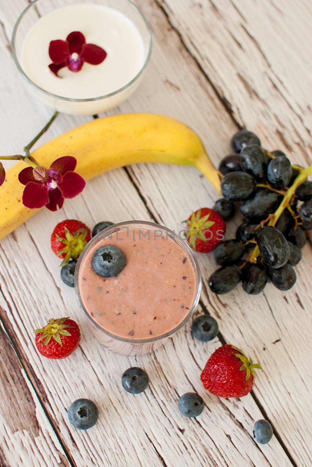 healthy organic fruit and nuts smoothie on wooden board