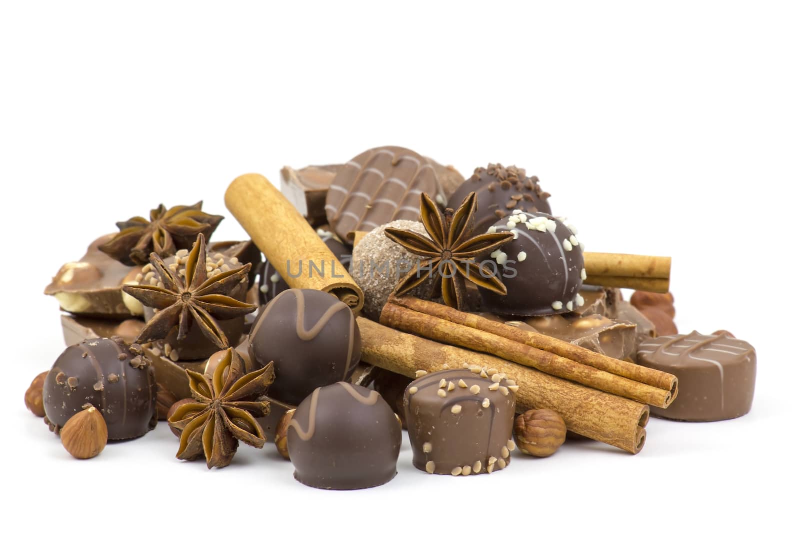 chocolate, spices and nuts on white background by miradrozdowski