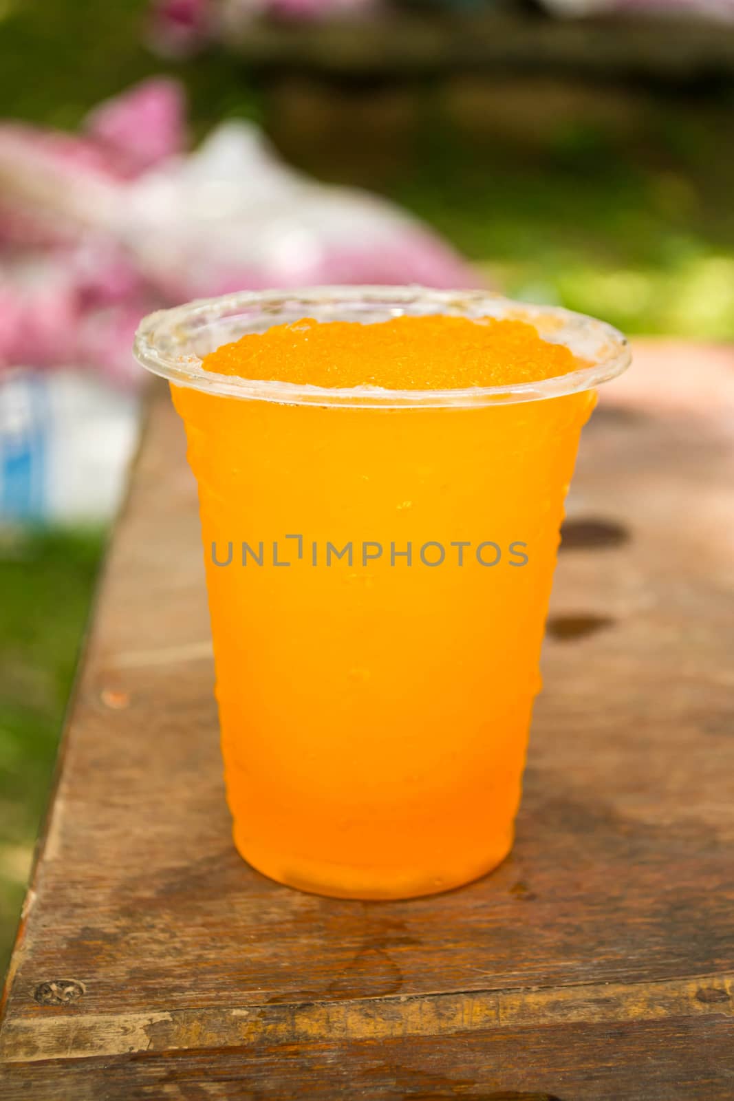 Soft drinks in plastic cups by Thanamat