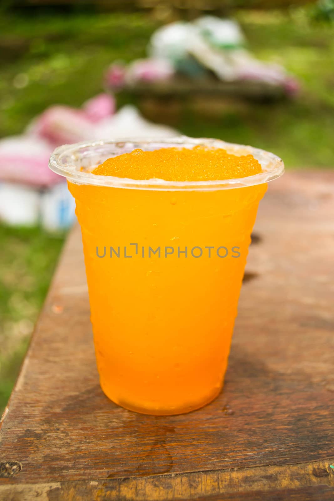 Soft drinks in plastic cups by Thanamat