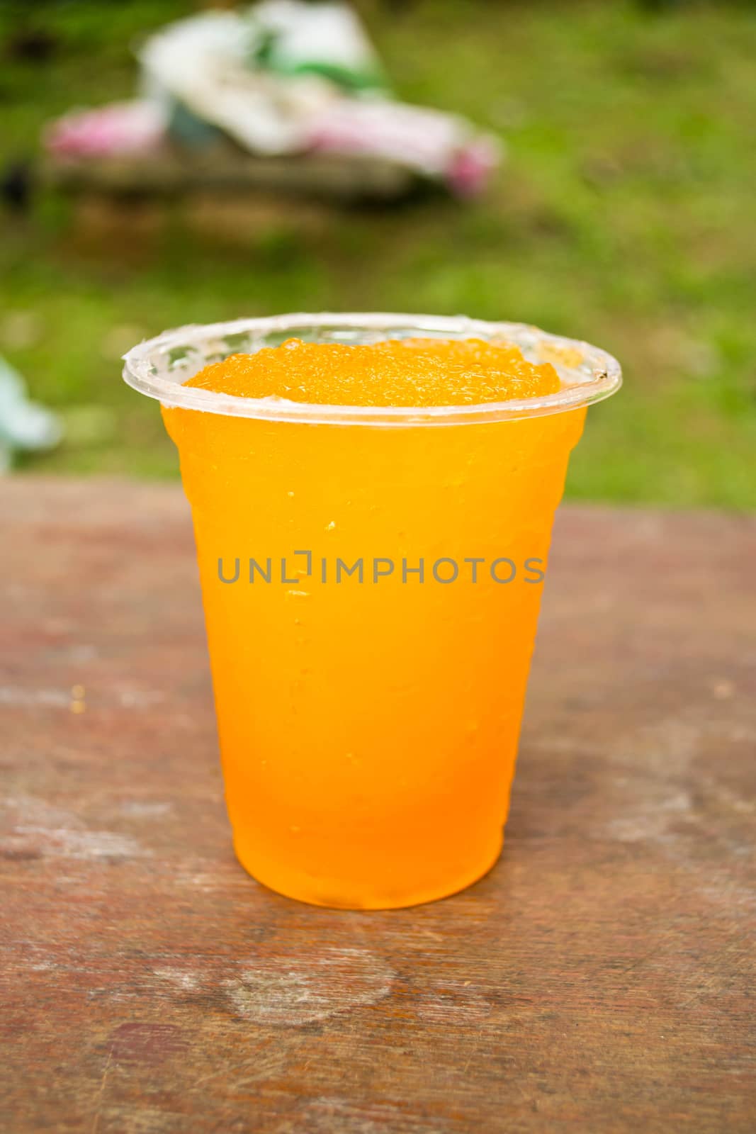 Soft drinks in plastic cups by Thanamat