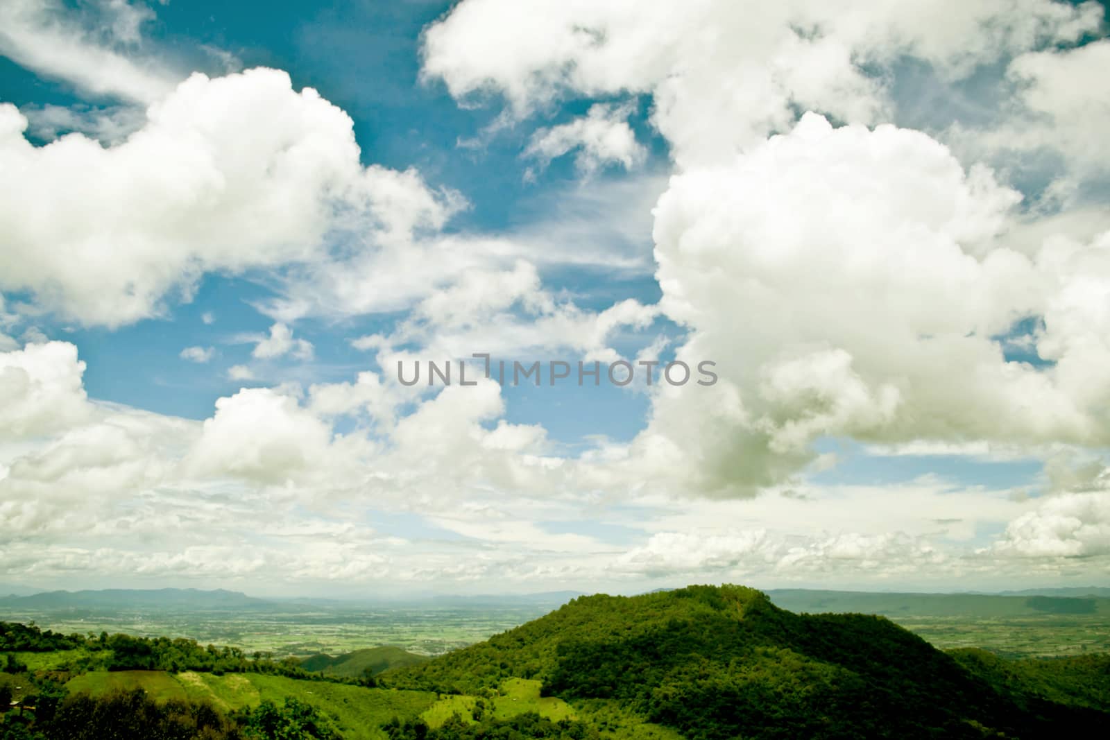 mountains green grass and blue sky landscape