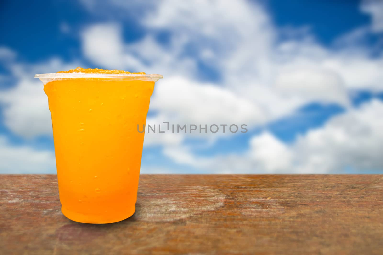 Orange juice in plastic cups on a background