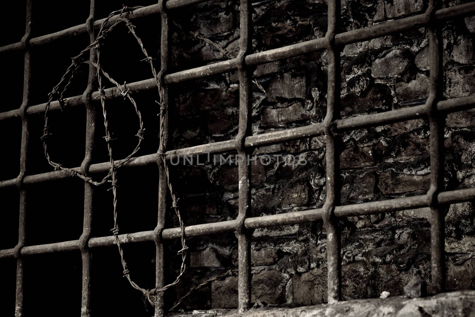 Burned up prison cell with barbed wire