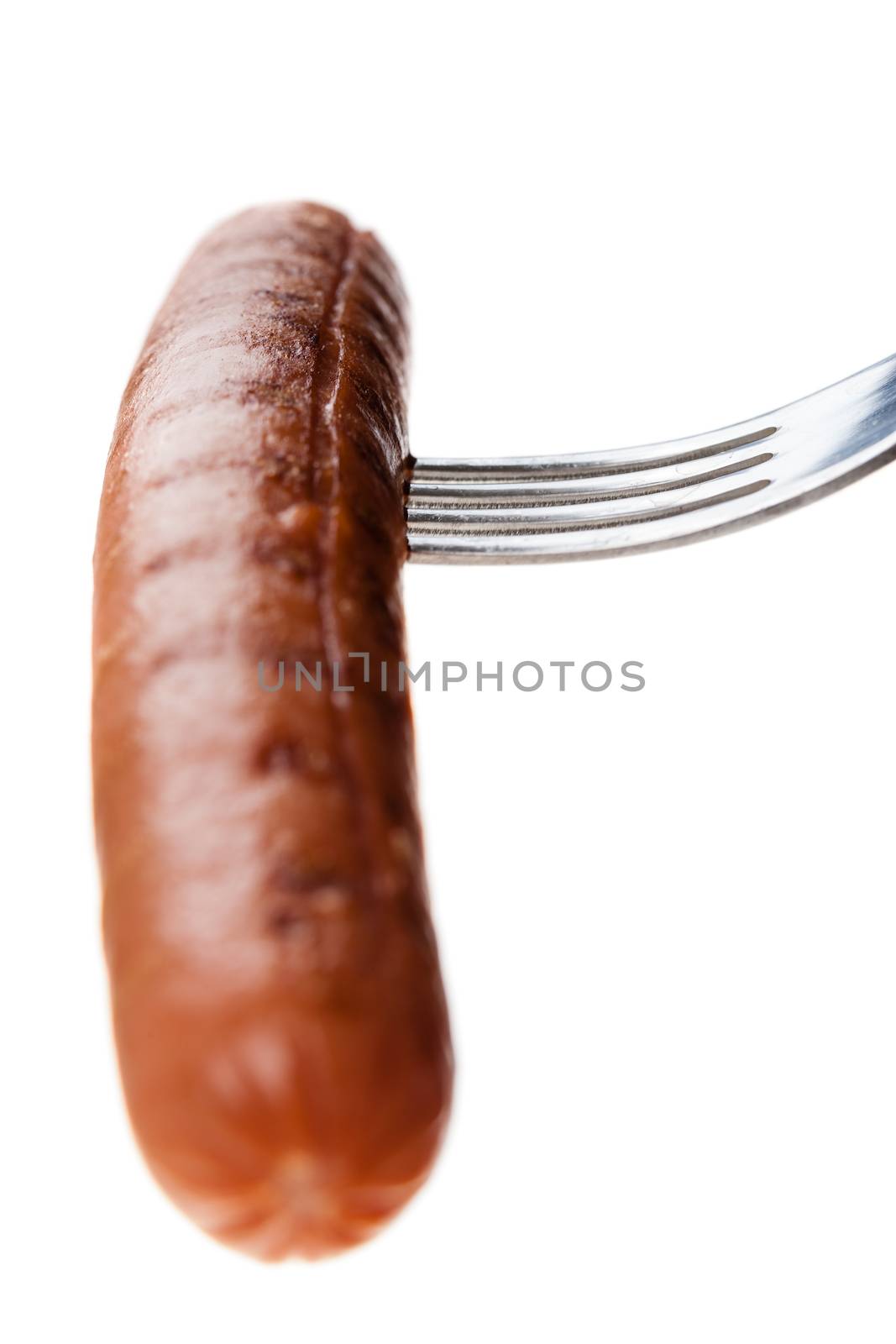 a delicious sausage on a fork over white