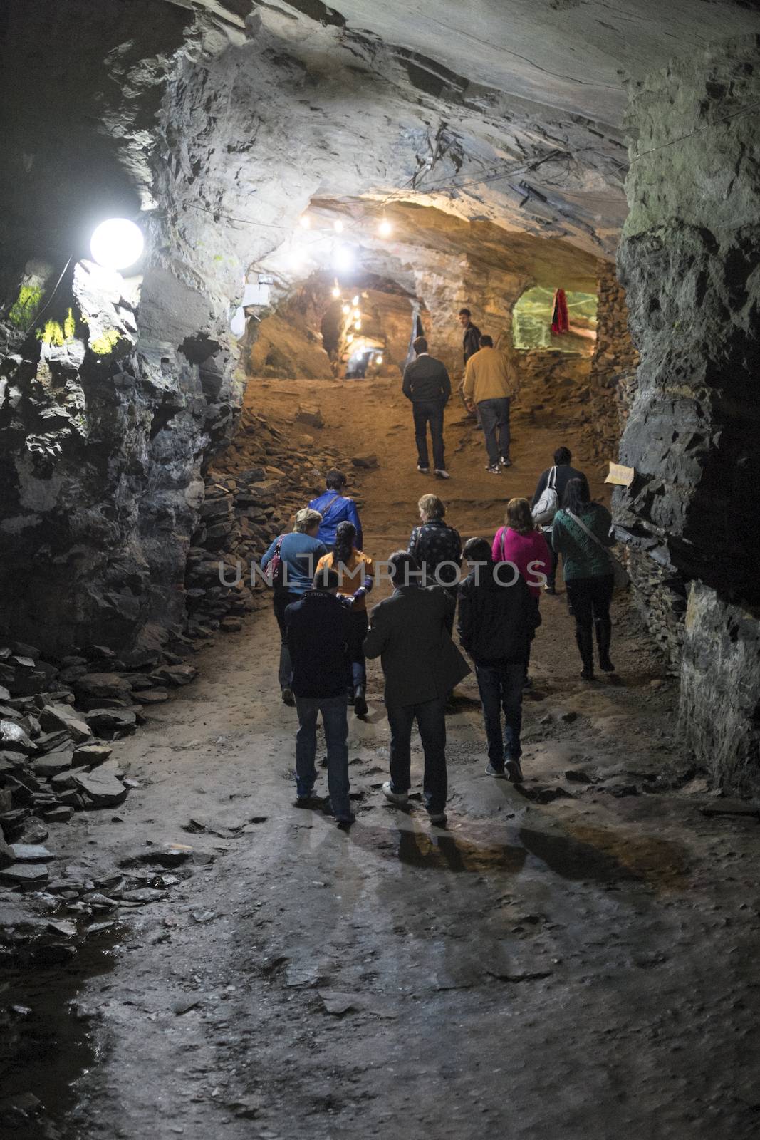 OURO PRETO, BRAZIL - JULY 27: Group of tourists explore the Passage Mines. Connecting two cities it is the largest disused gold mine open to visitation in the world. July 27, 2014 in Ouro Preto.