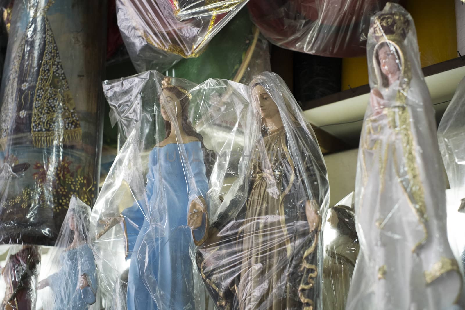 BELO HORIZONTE, BRAZIL - JULY 28: Religious icons wrapped in plastic in Brazilian market. The saints are significant to Catholicism and African-Brazilian religions. July 28, 2014 in Belo Horizonte.