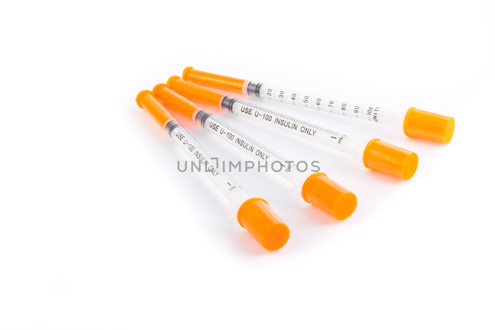 Four insulin syringes isolated on white