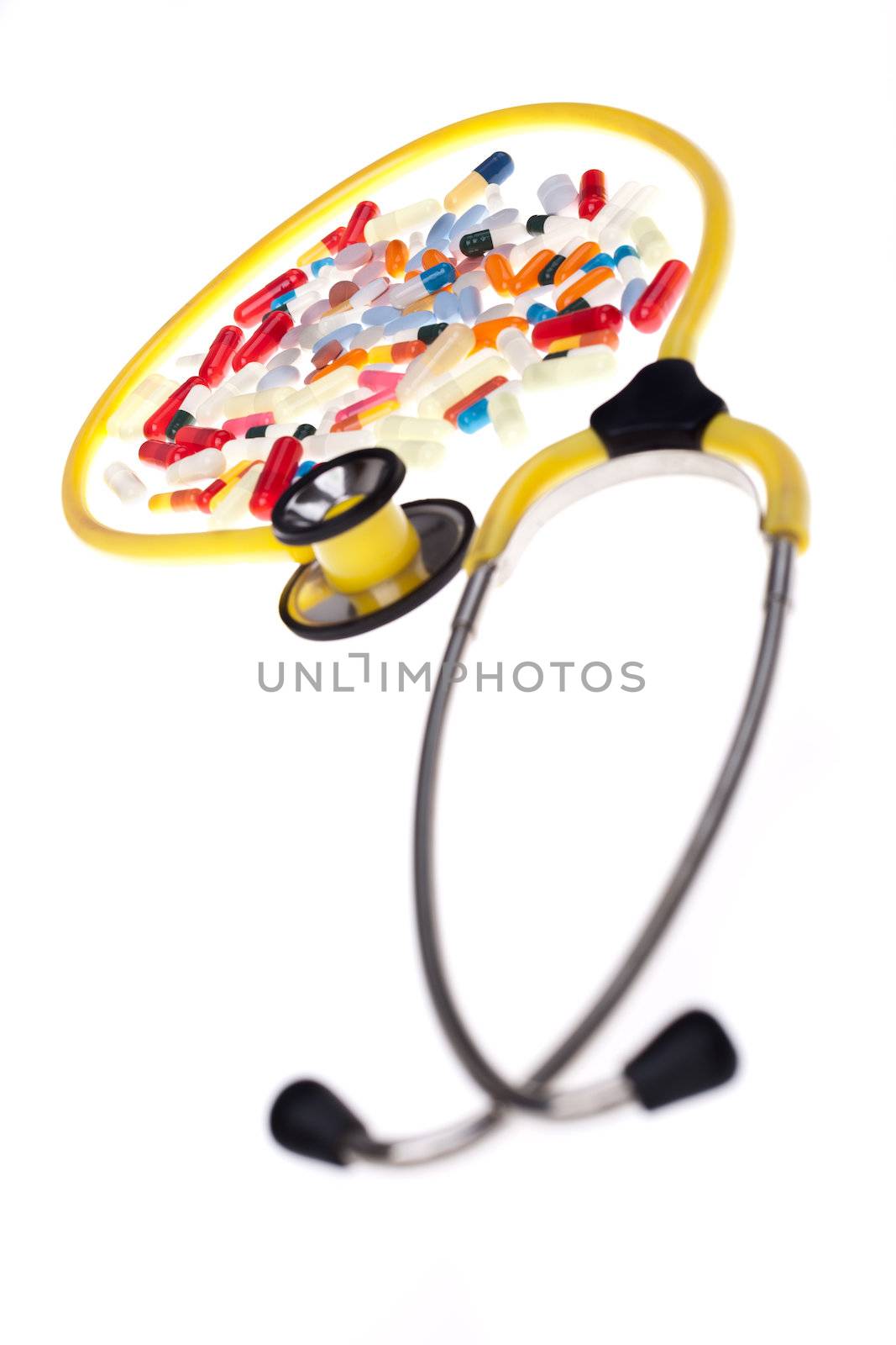 Pills and yellow stethoscope by dario_lo_presti