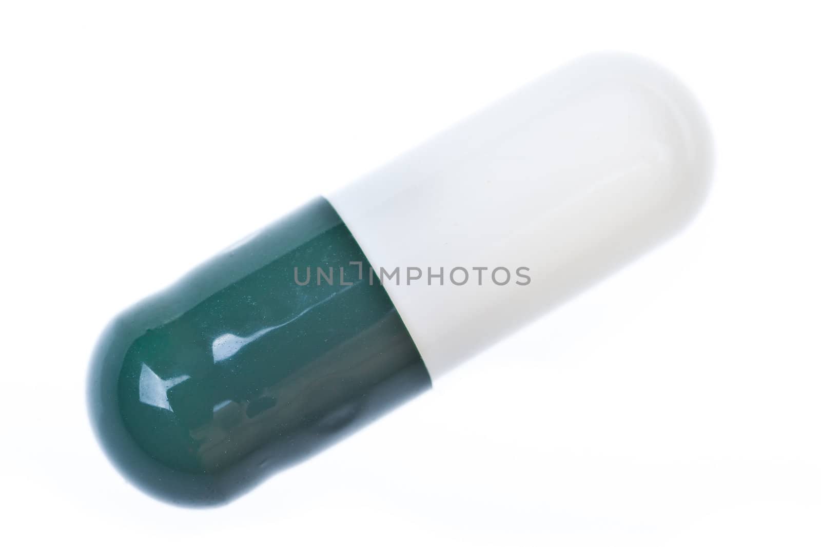 Extreme macro of a single pill over white background