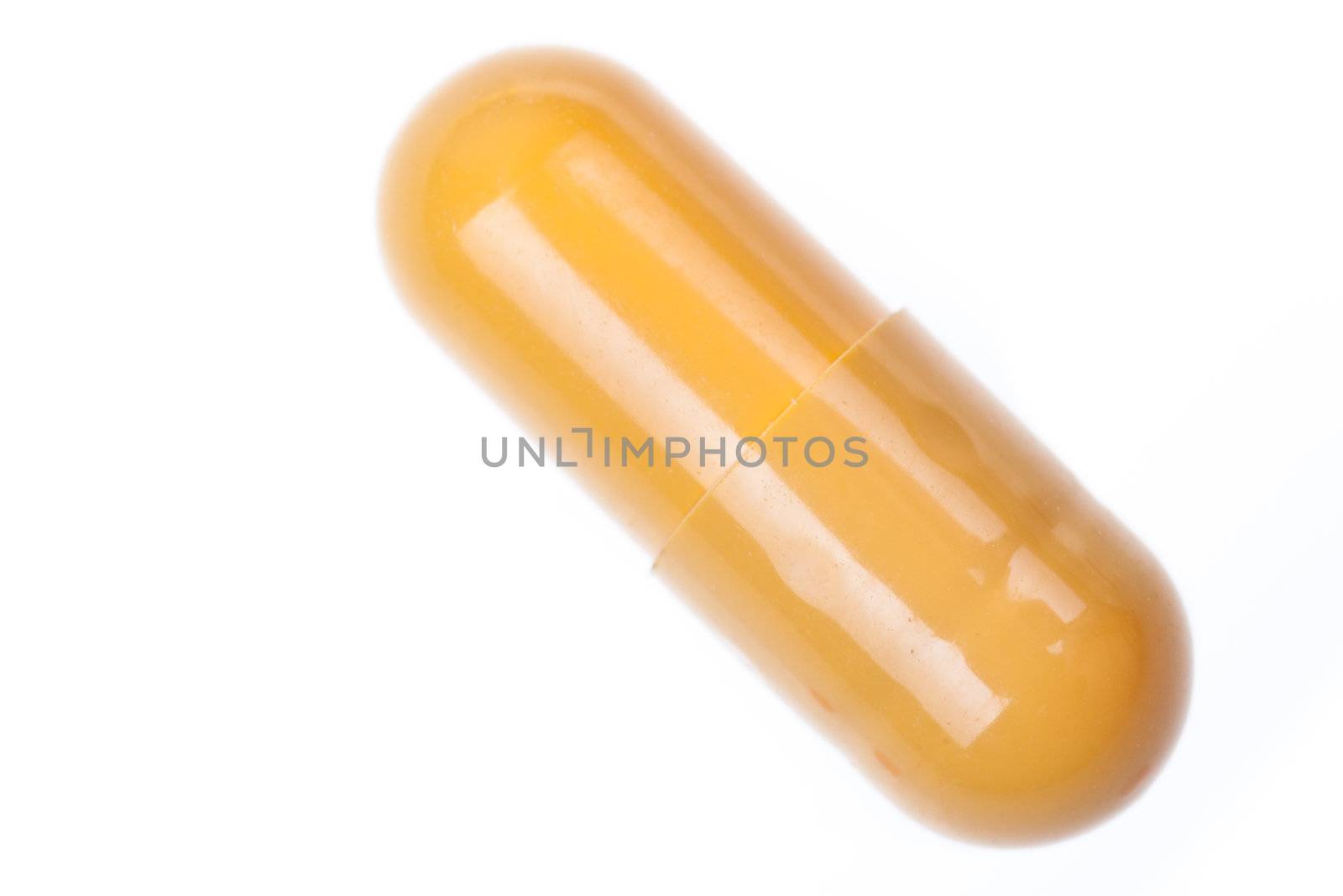 Extreme macro of a single pill over white background