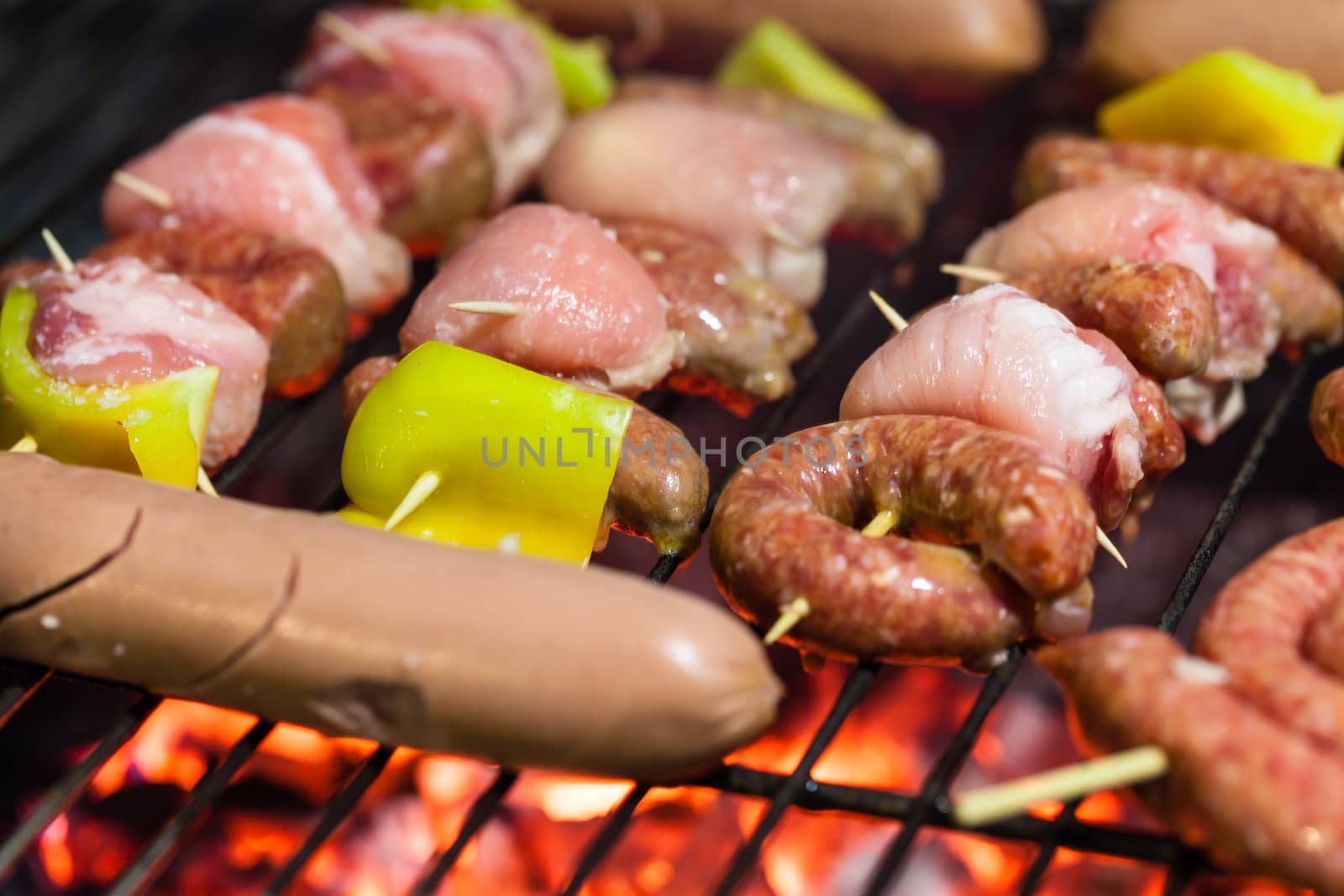 different types of meat cooking outside on a barbecue