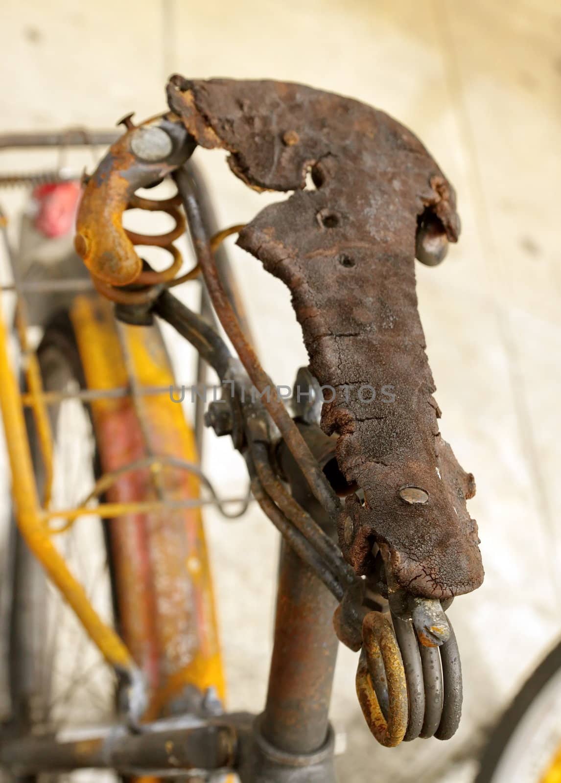 Close up on saddle of burnt bicycle in the street