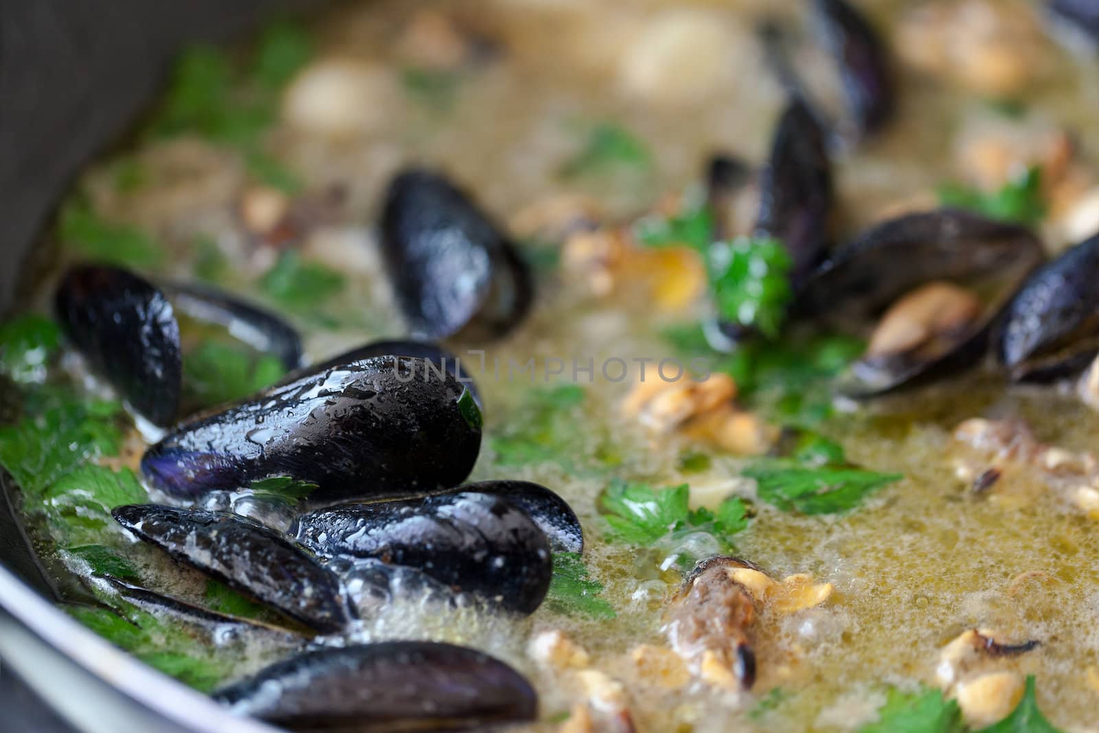 Mussels cooking in a frying pan