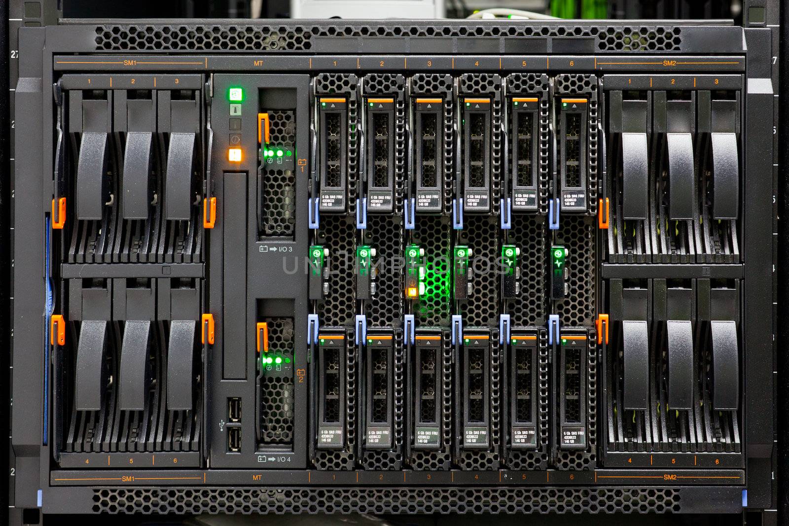 Network Server Rack Panel with hard disks in a data center.