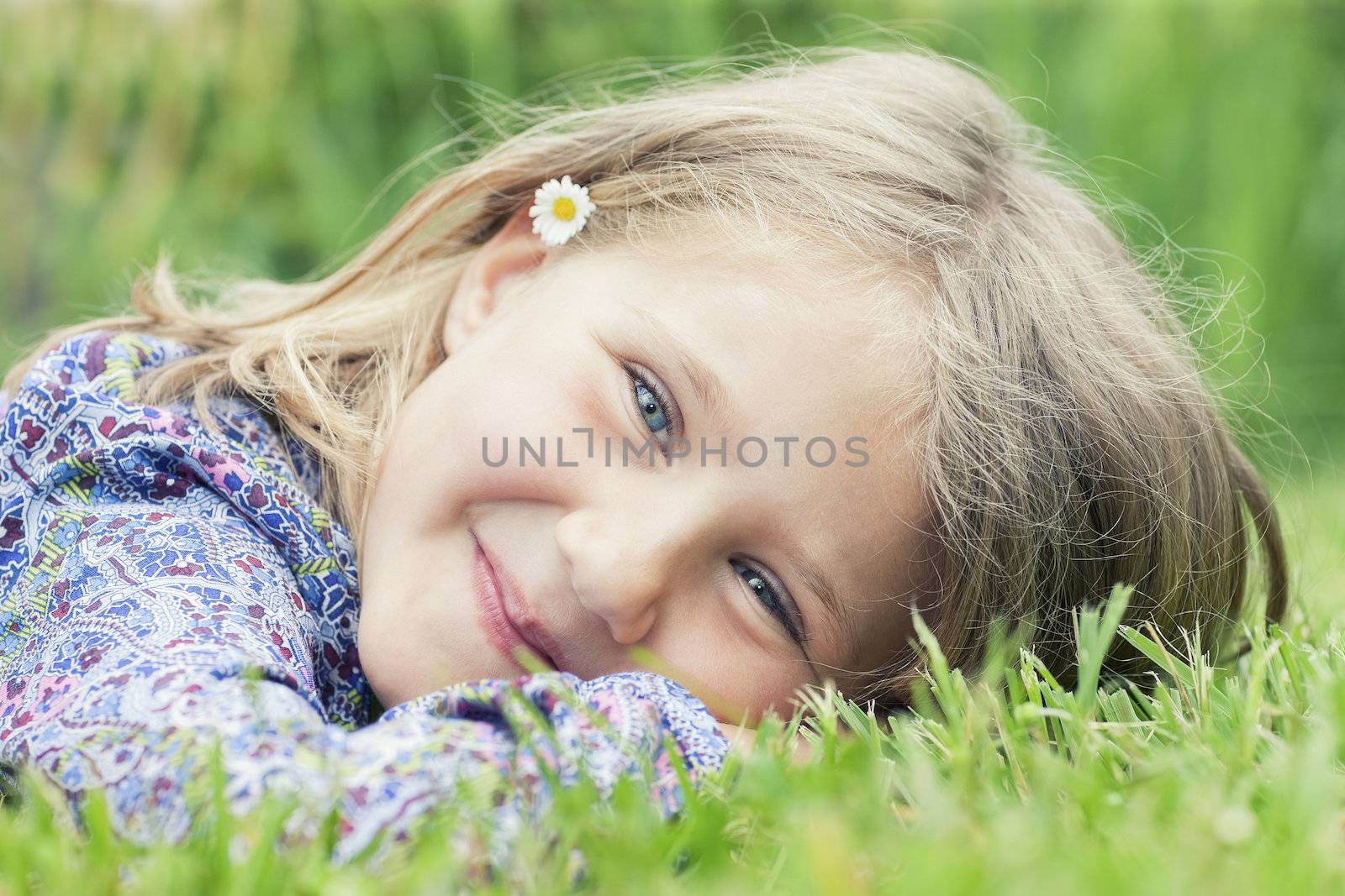girl lying on grass smiling by vwalakte