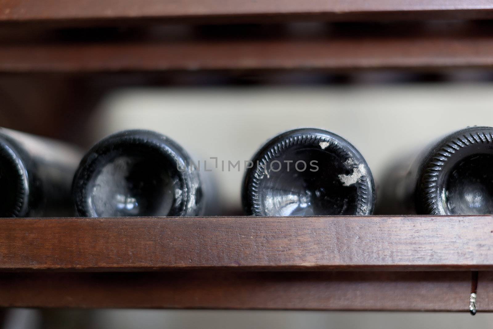 some very old and dusty wine bottles in a wine cellar