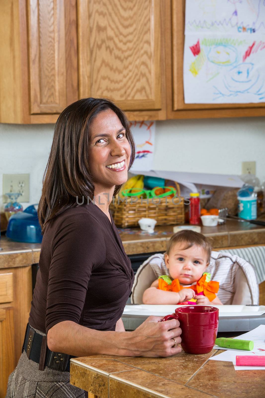 Smiling mother poses with her baby