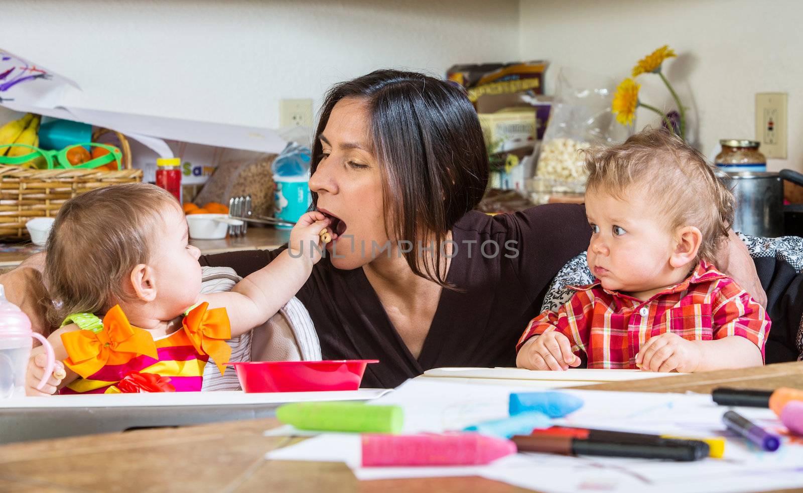 A Baby feeds her mother at breakfast