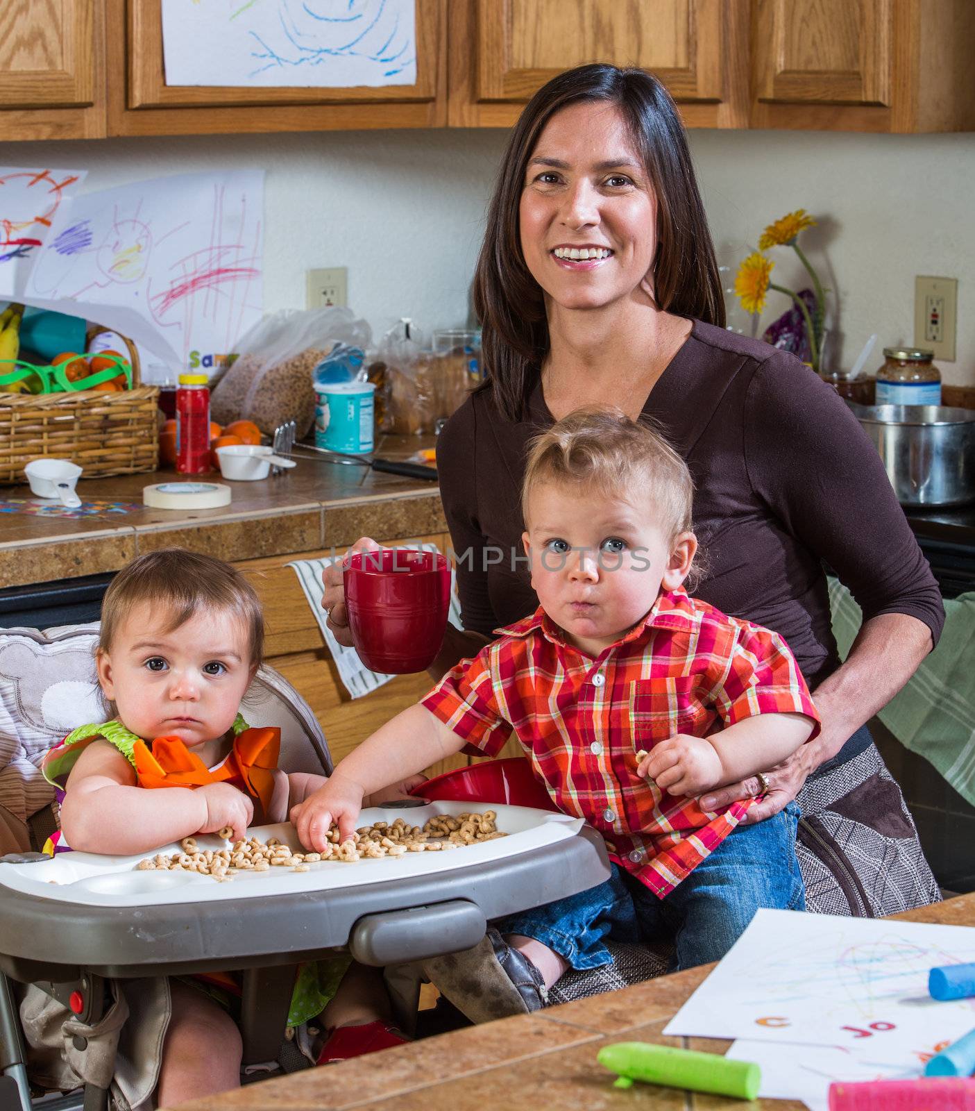 Mother poses with children in the kitchen