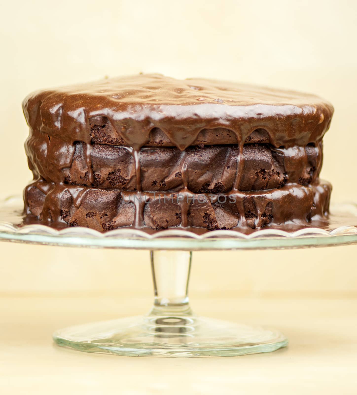 Delicious melted chocolate cake on brown background by marius_dragne