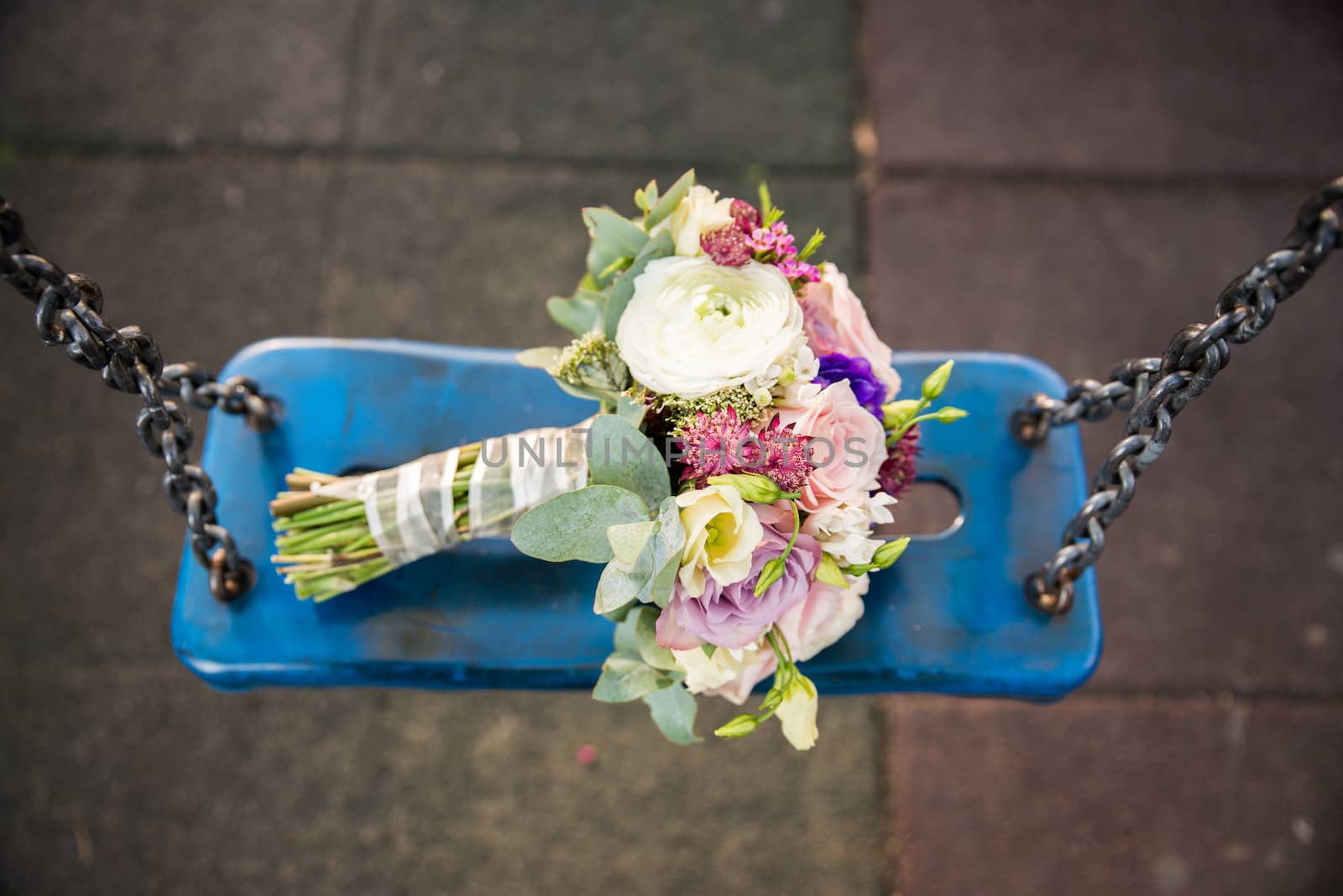 Bride bouquet on blue swing with chains