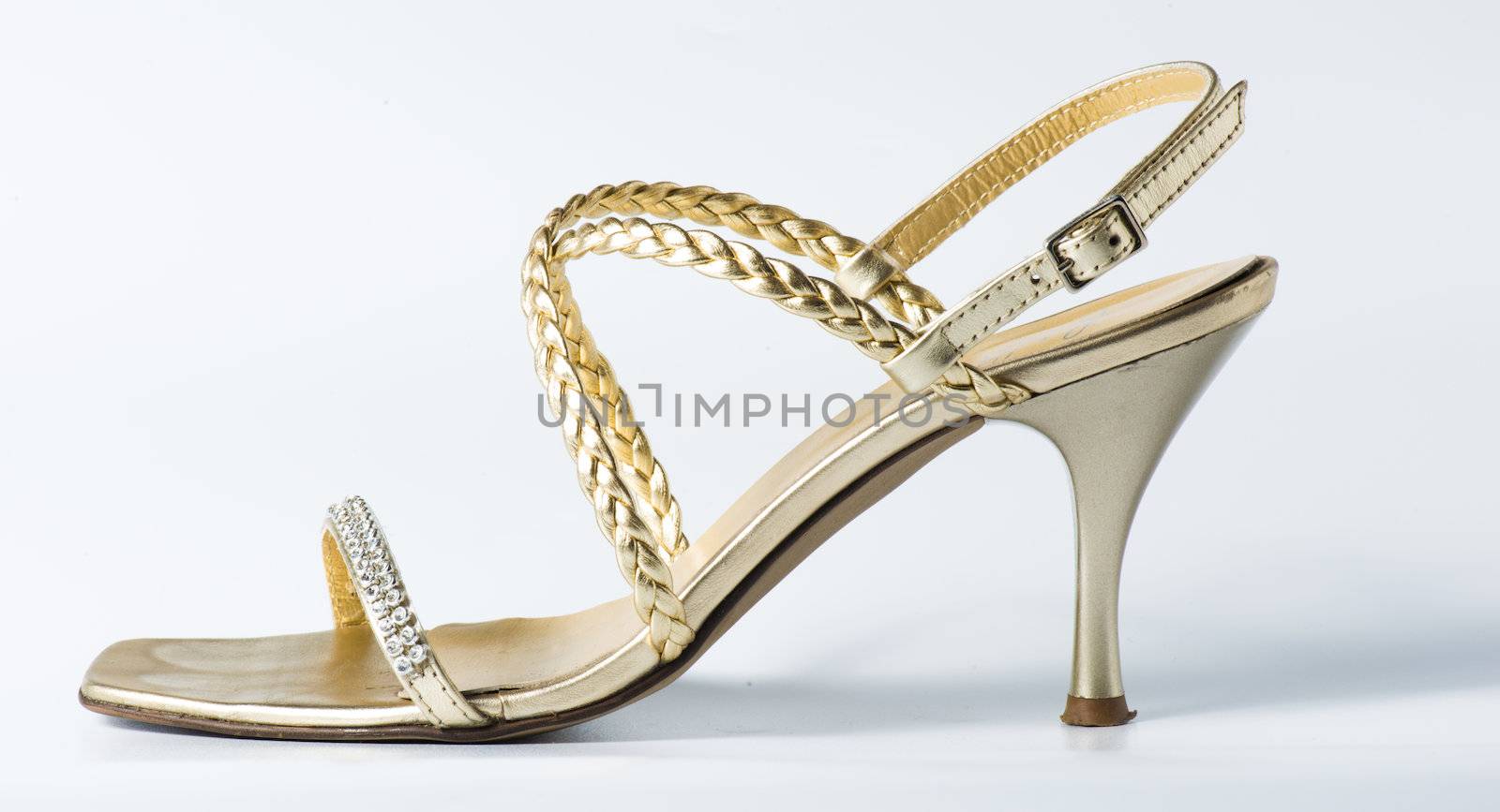 Woman golden shoes on white background
