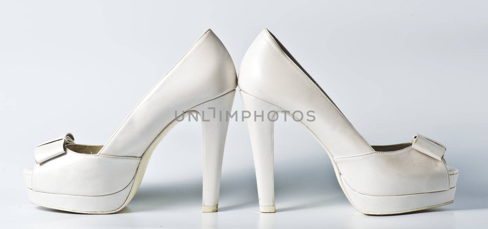 Woman white shoes on white by marius_dragne